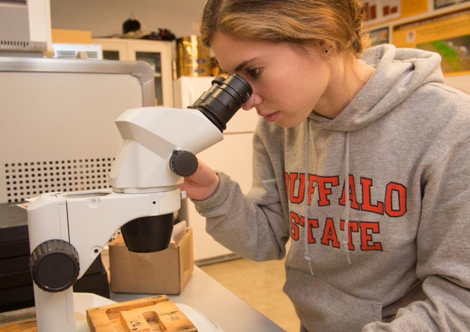 Student looking into microscope