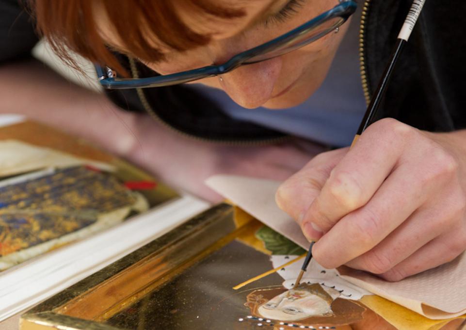 Art conservation student working on a painting