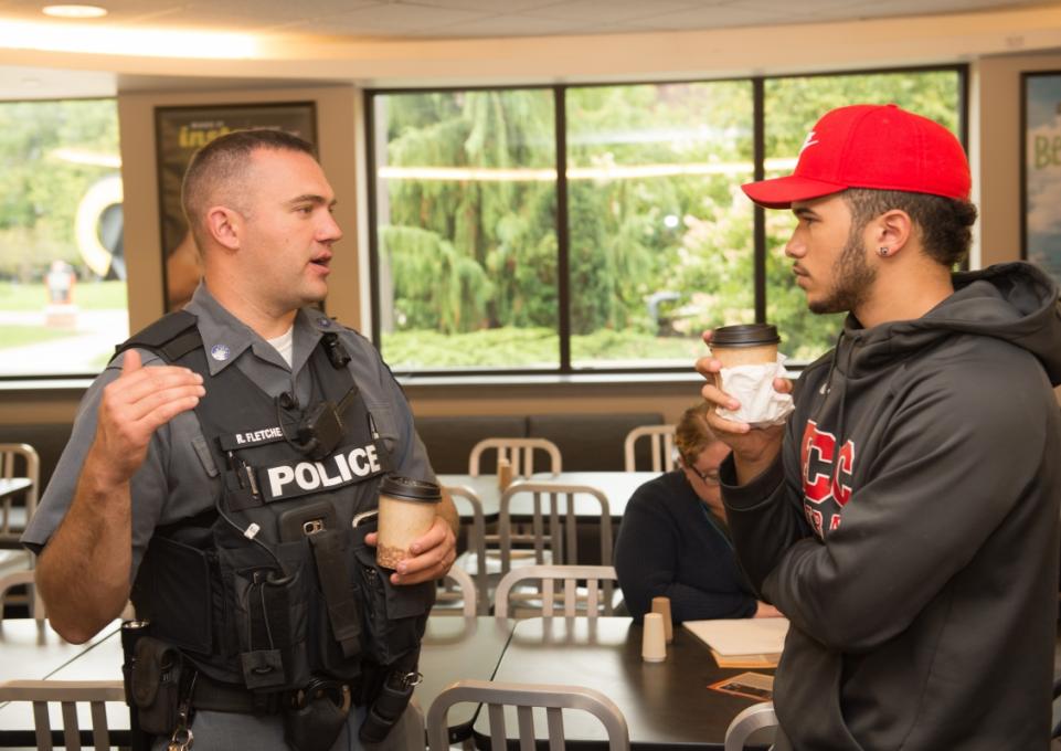 Police officer talking with student