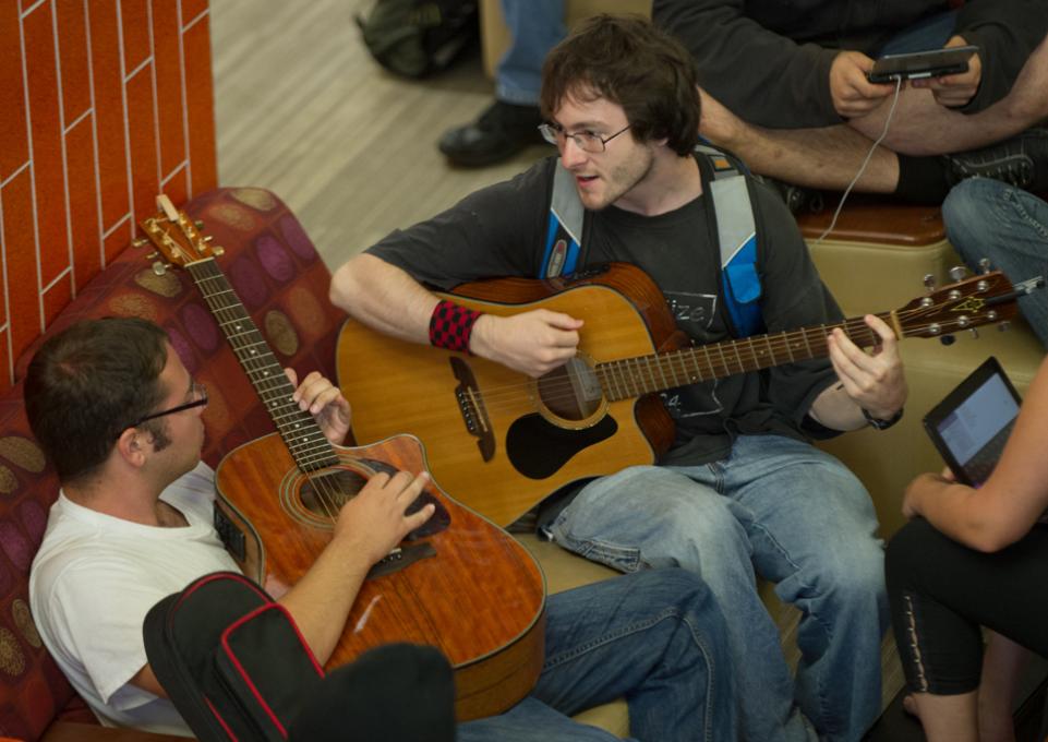 Students playing guitars