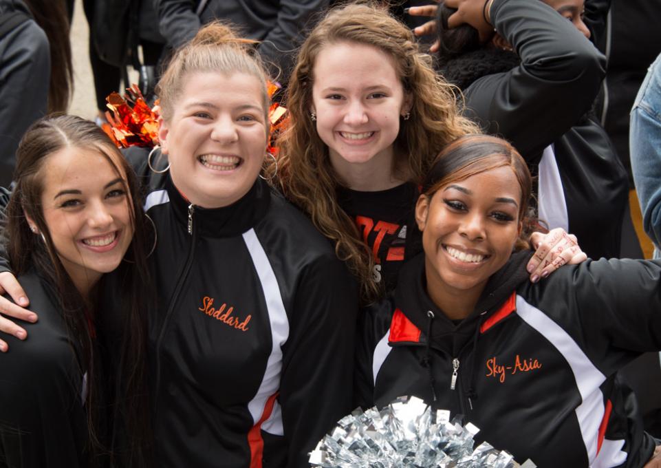 Four cheerleaders at homecoming football game