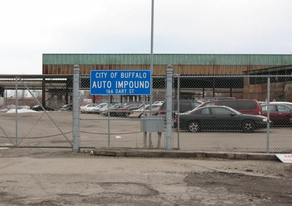 Auto Impound Lot w/ sign on fence