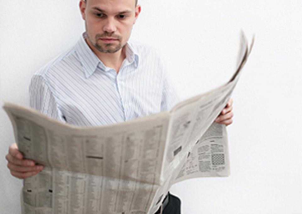 man reads newspaper