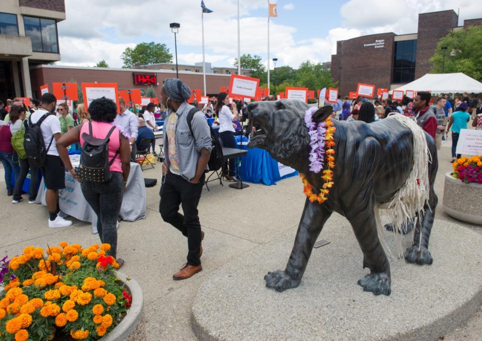 Students visiting the job luau tables