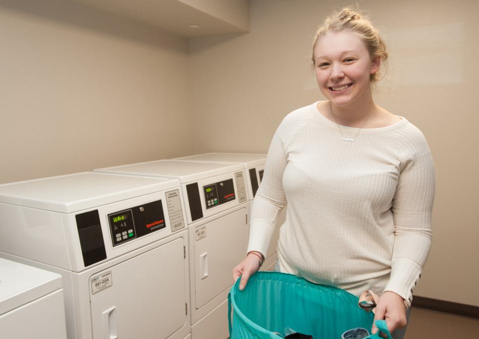 Student doing laundry in Bishop Hall