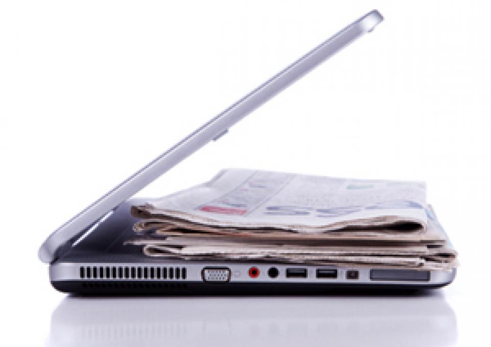 newspaper on laptop keyboard