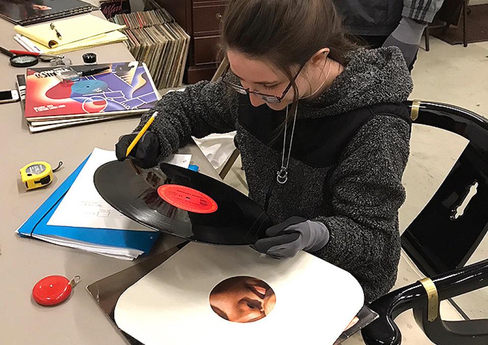  student Mary Langille holding a phonograph record